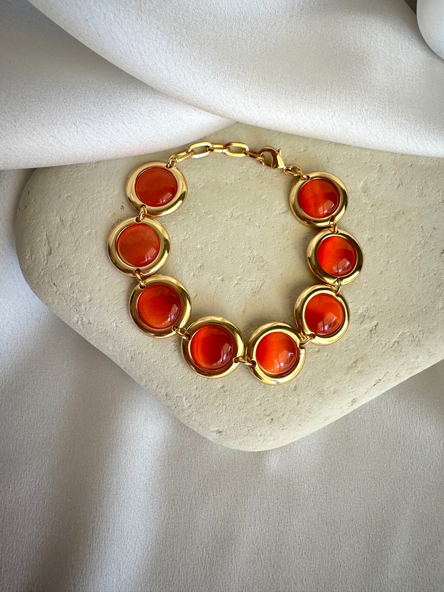 Gold plated stainless steel bracelet with colorful enamel beads in coral, pink, green, and white