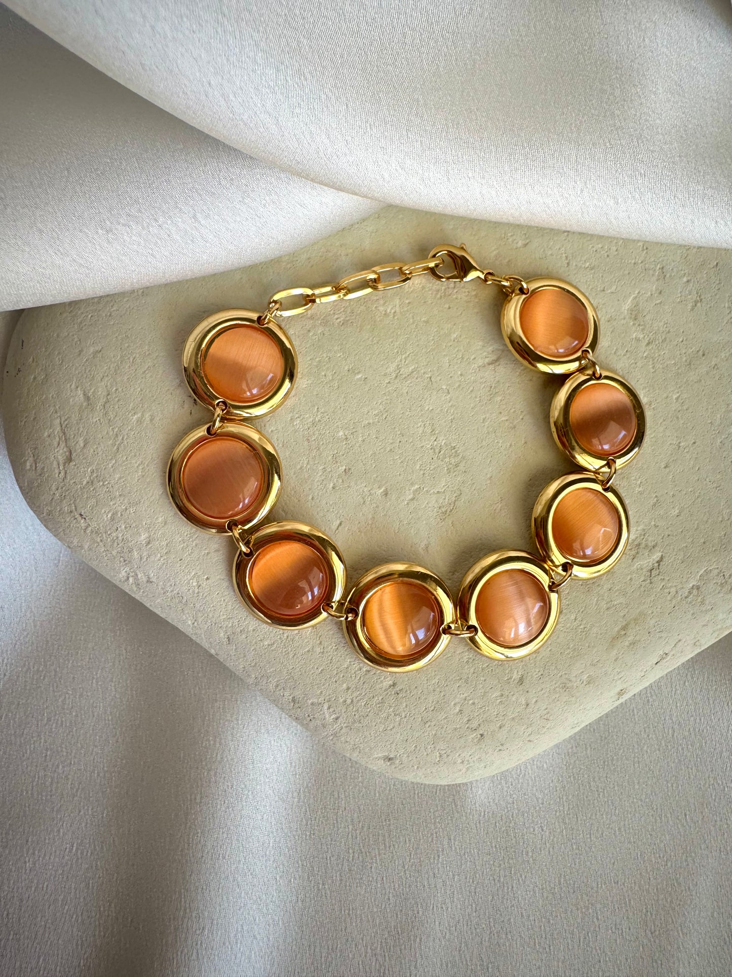 Gold plated stainless steel bracelet with colorful enamel beads in coral, pink, green, and white