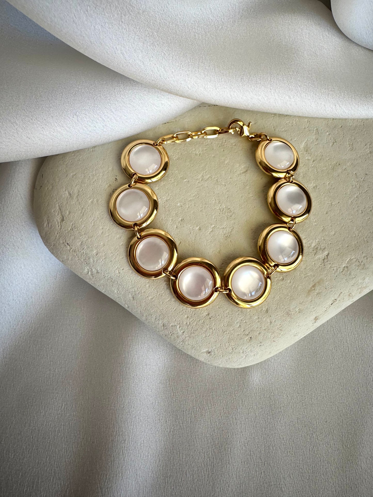 Gold plated stainless steel bracelet with colorful enamel beads in coral, pink, green, and white