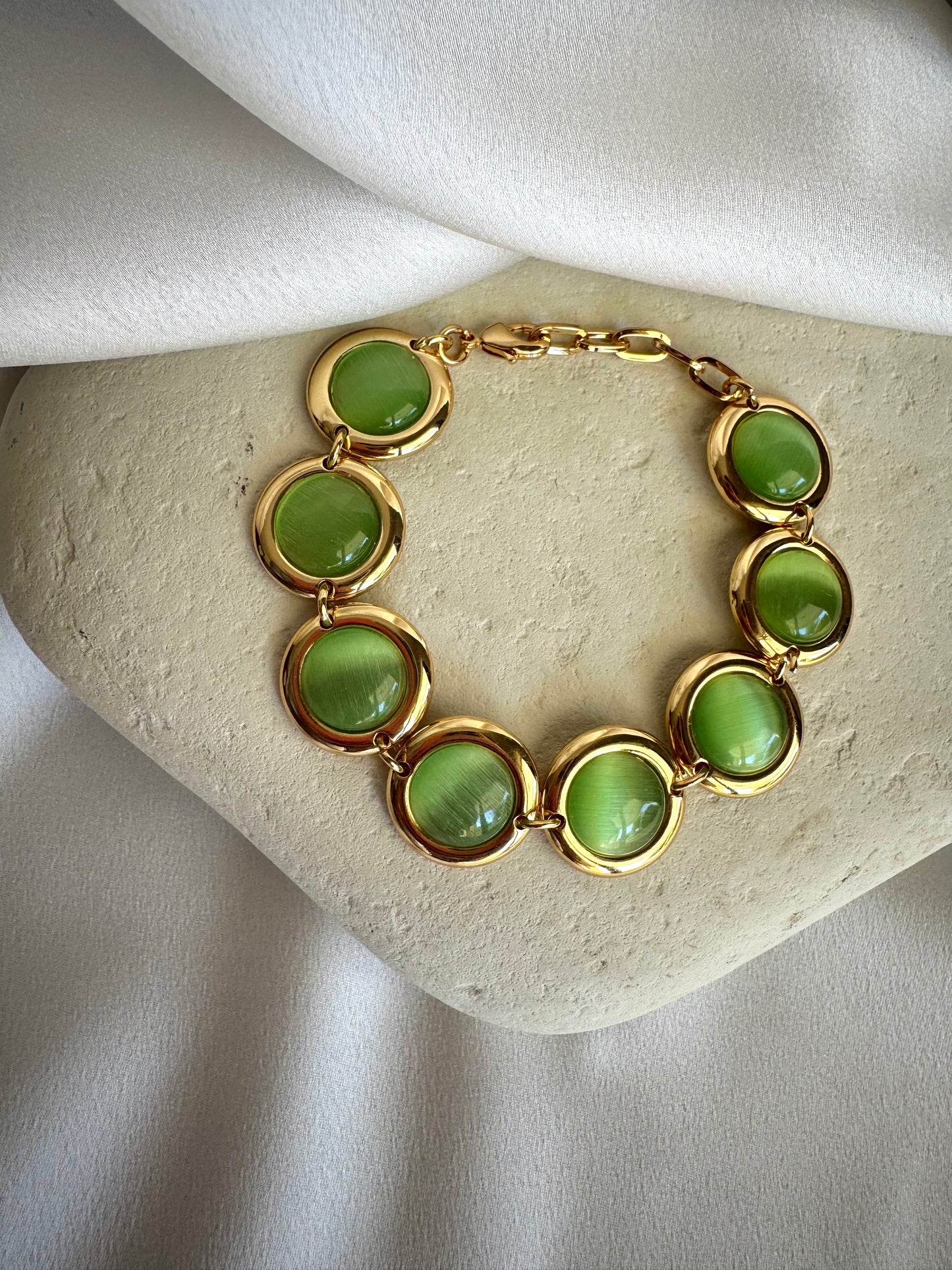 Gold plated stainless steel bracelet with colorful enamel beads in coral, pink, green, and white