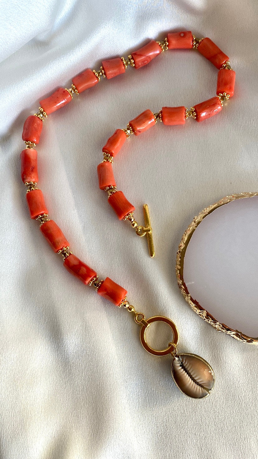 Handcrafted coral beaded necklace with gold hematite and cowrie shell pendant