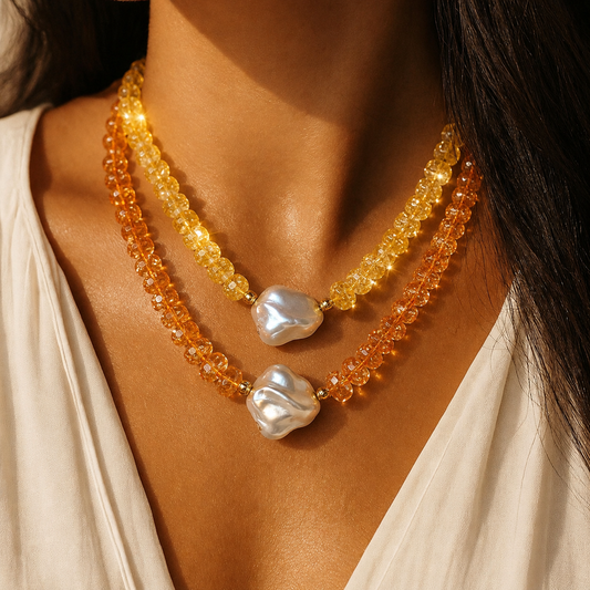 Necklace with orange and yellow beads and mother of pearl worn by a woman
