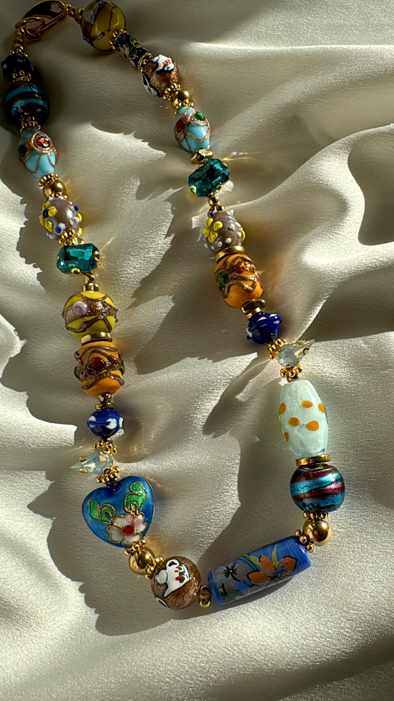 Close-up detail of colorful Murano beads and gold hematite accents on SAMIRA necklace