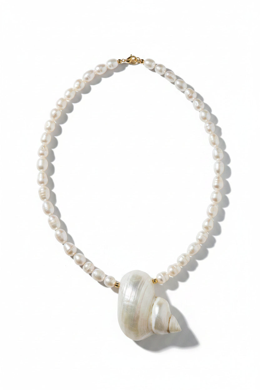 Pearl necklace with a large white natural shell as a centerpiece
