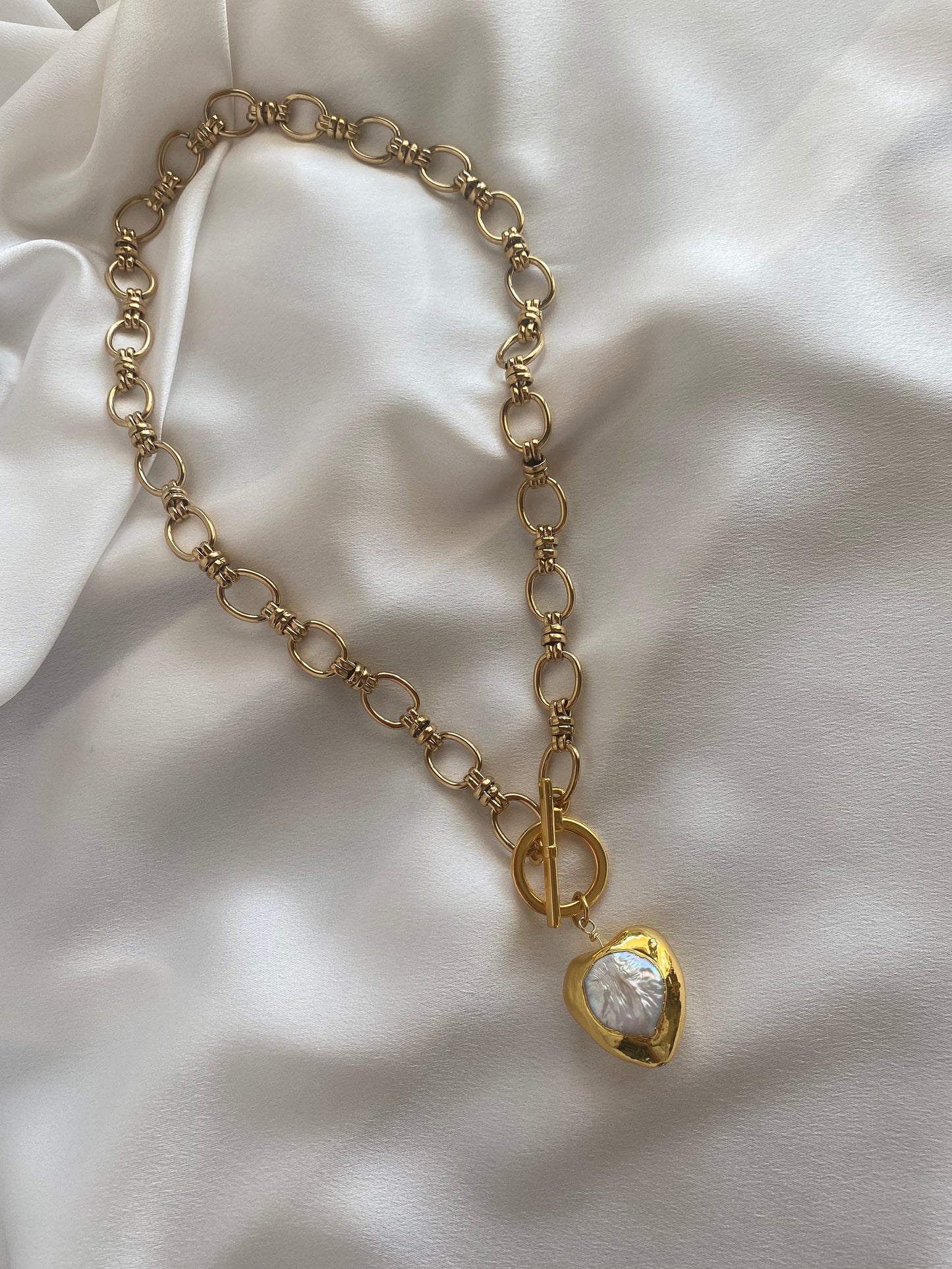 Gold plated necklace with chunky Mother of Pearl heart pendant and front toggle clasp