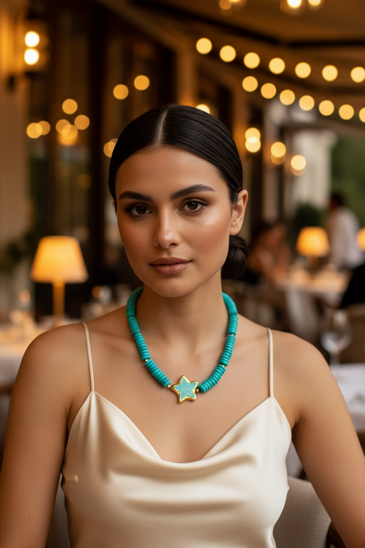Woman wearing a turquoise necklace with a starfish pendant in an outdoor restaurant setting