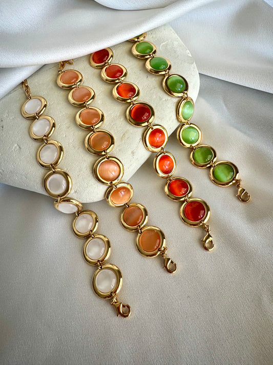 Gold plated stainless steel bracelet with colorful enamel beads in coral, pink, green, and white