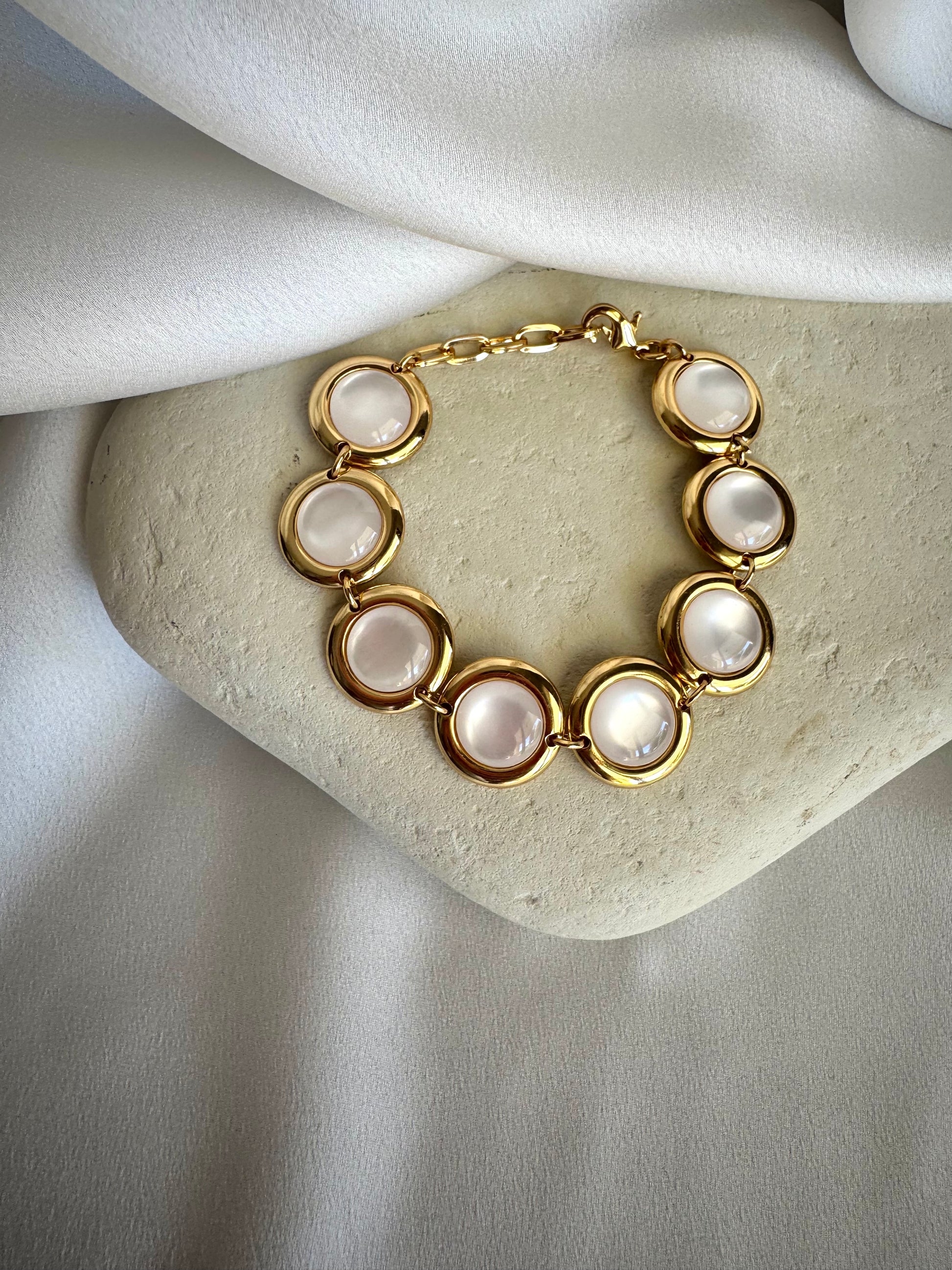 Gold plated stainless steel bracelet with colorful enamel beads in coral, pink, green, and white