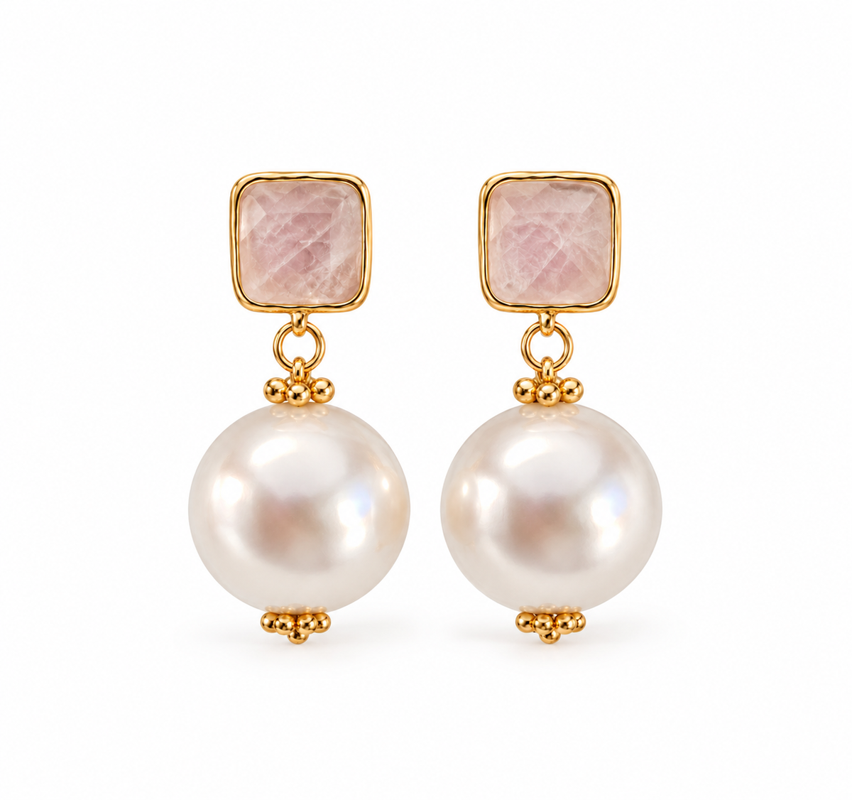 A pair of gold drop earrings featuring a square pink stone top and a large round white pearl drop, set against a plain white background.