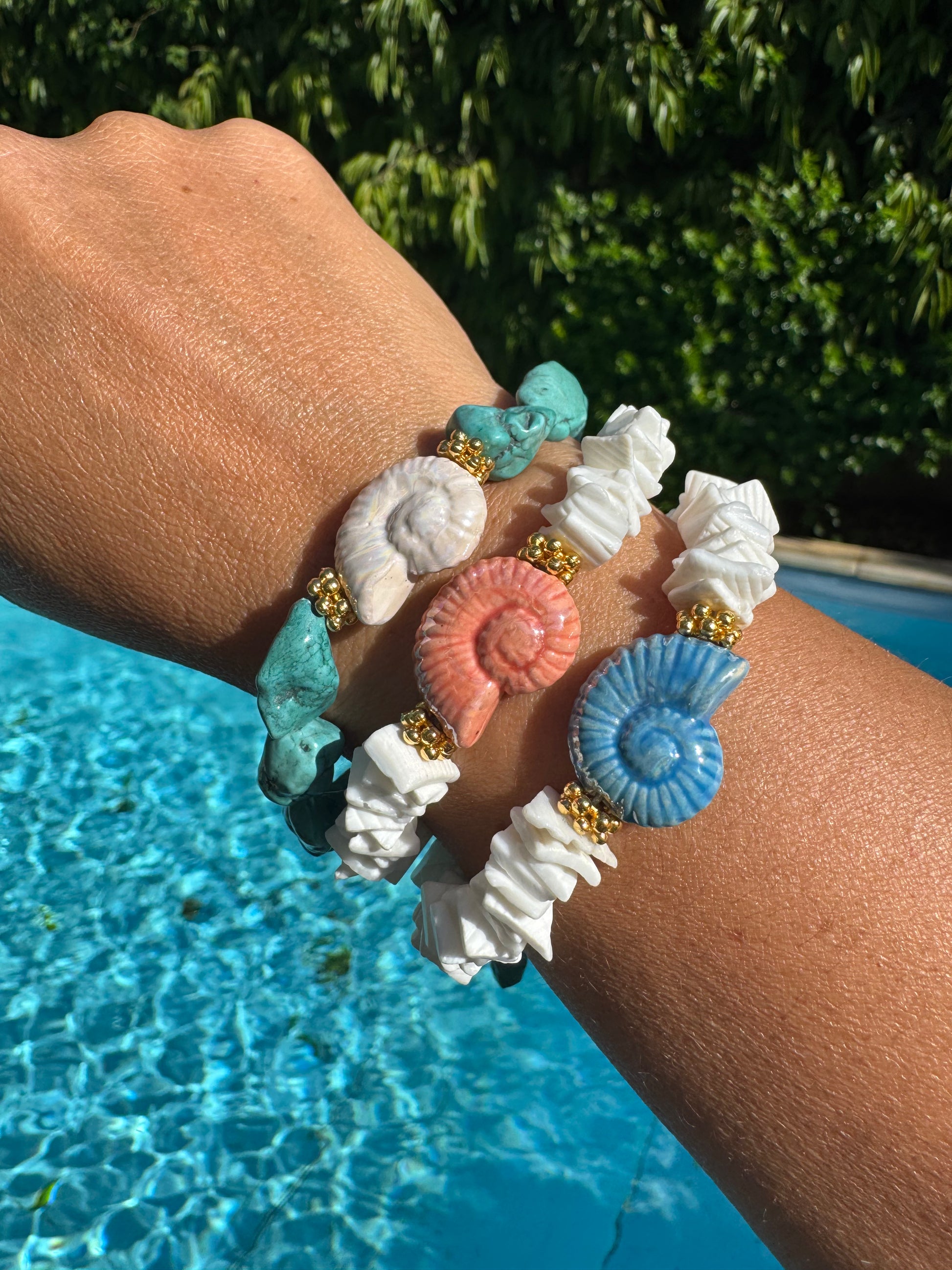 Woman wearing MYKONOS shell bracelet  by the pool