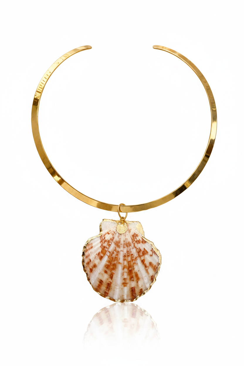 A gold-toned circular collar necklace featuring a dangling scallop shell pendant with a white base and orange-brown ribbed pattern, shown on a clean white background with a soft reflection below.