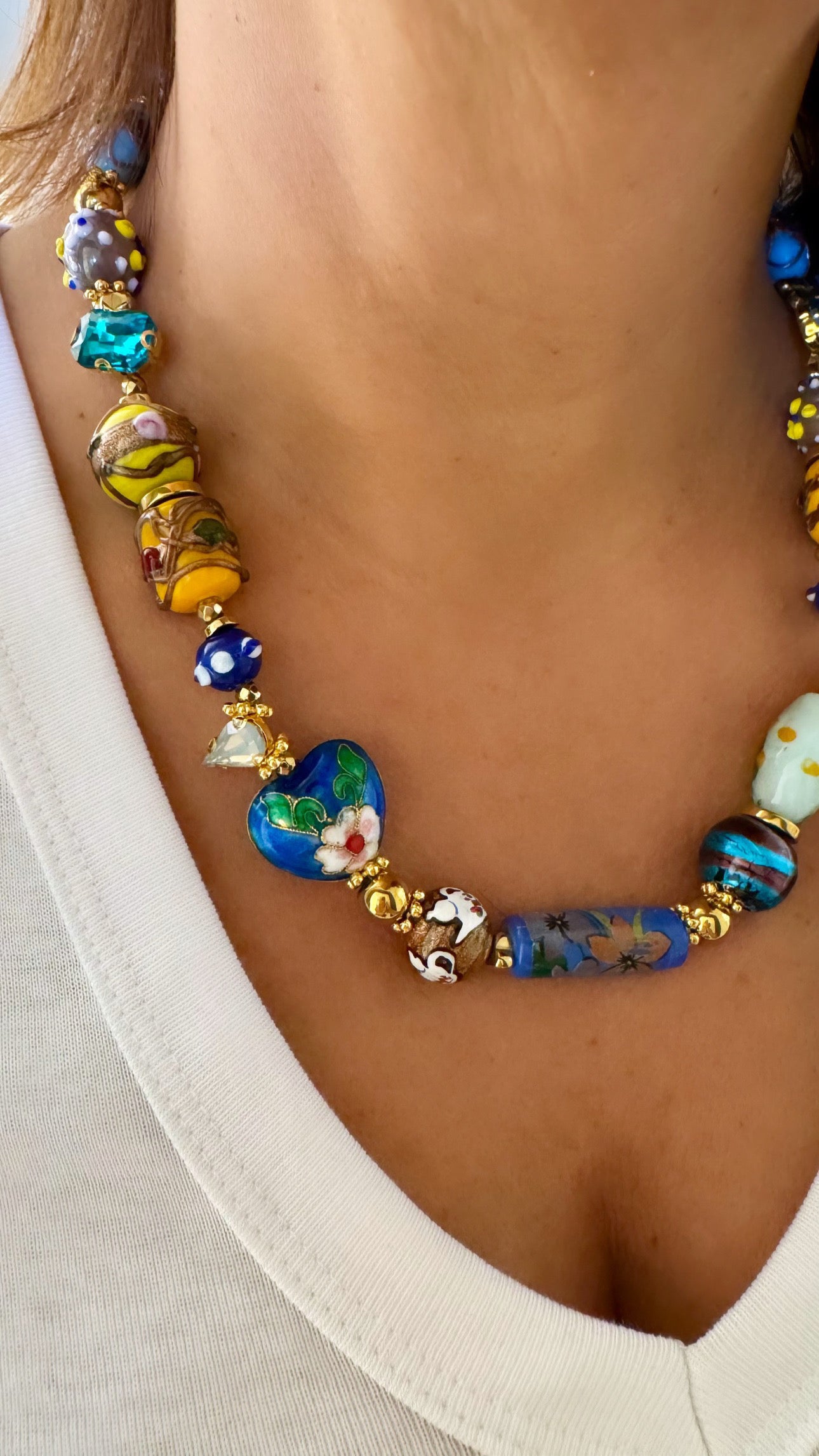 Woman wearing SAMIRA Murano glass necklace layered over white blouse