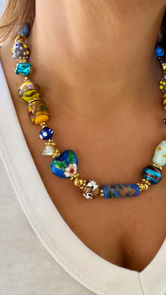 Woman wearing SAMIRA Murano glass necklace layered over white blouse