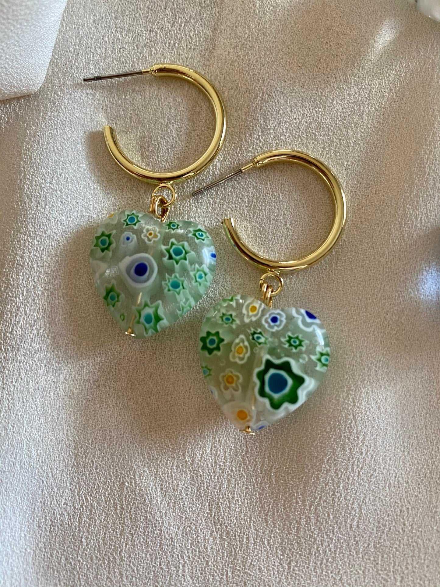 Murano heart earrings on gold hoops