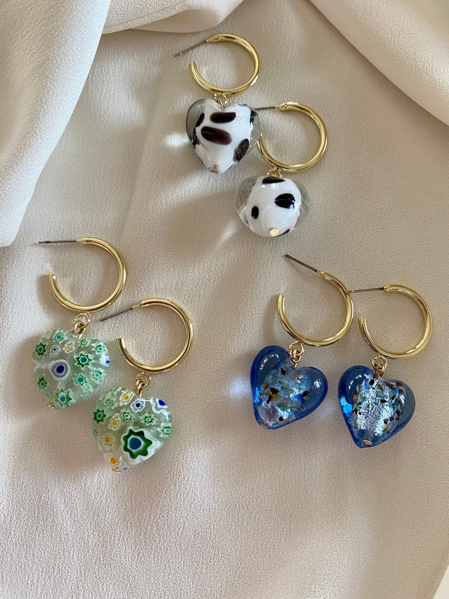 Murano heart earrings on gold hoops